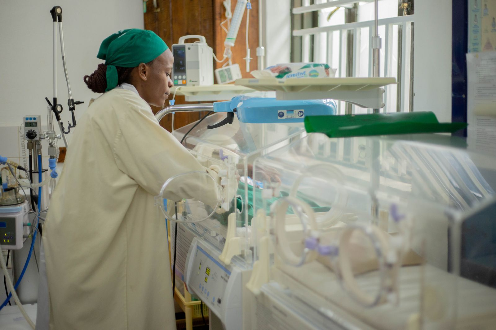 Nurse caring for a newborn in a neonatal unit